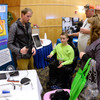 An occupational therapist with the Utah Center for Assisted Technology showcases available devices. Photo credit U.S. Air Force.